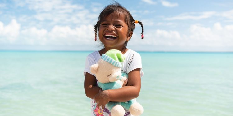A girl from Kiribati loves the new “wow” toy she found in her shoebox gift. (Photo is courtesy of Samaritan’s Purse)