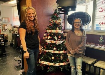 New Image Tattoo Studio staff member Jess Hoyt, left, and owner Chris Shaffer, have put up their fundraising Christmas Tree at the studio in support of MRAAA.