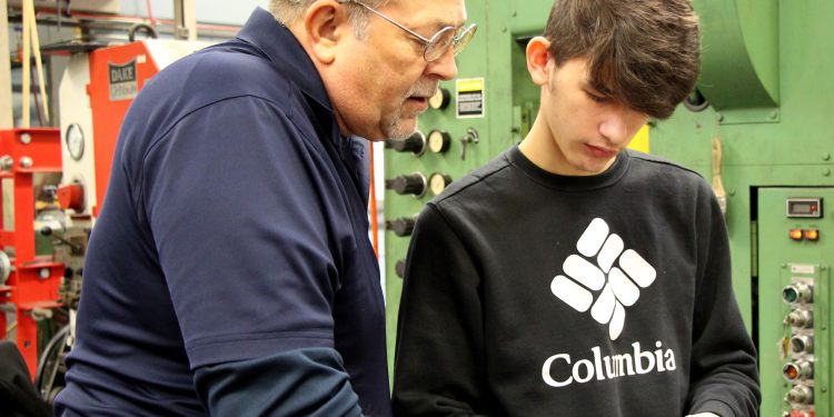 Penn State DuBois die setting instructor George Schneider, left, works with Saint Marys Area High School student Dakota Larkham to measure one of the parts produced during the high school die setter training program. (Submitted Photo).