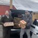 MRAA Director of Communications Steve Harmic, left, receives a donation of food items to benefit the Meals on Wheels and More program from Country Butcher owner Jason Gill, right.