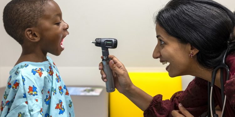 Dr. Banku Jairath of Penn State Health Milton S. Hershey Medical Center’s Department of General Pediatrics, examines 4-year-old Adrian Shank, Jr.
