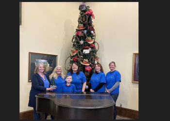 Kristen Zurat of the Chemo Care Bag Project, at left, hands off the Festival of the Trees traveling trophy to the latest winners, staff and volunteers with Full Circle Ranch Equine Haven. They are, left to right, Nancy Taylor, Sean McKeegan, Marty Butler, Suzanne Mosch, and Geremy Kephart.