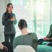 Shot of a young woman talking during a group therapy session.