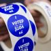 A poll worker holds voting stickers for community members Nov. 7, 2023, at Central Elementary School in Allentown, Lehigh County, Pennsylvania.

Matt Smith / For Spotlight PA