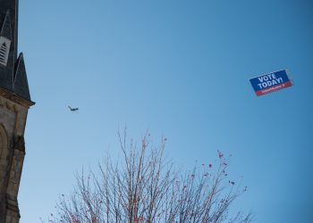 A VotesPA.com banner is flown behind a plane over downtown Erie on Election Day 2022.

Robert Frank / For Spotlight PA