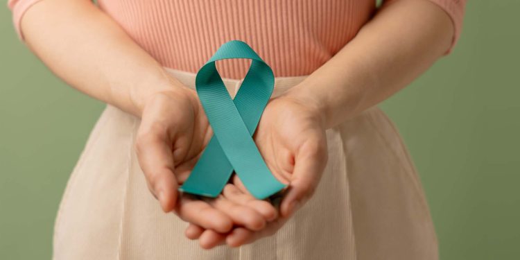 Ovarian and Cervical Cancer Awareness. Woman Holding Teal Ribbon on Lower Abdomen, Uterus, Female Reproductive System, Women's Health, PCOS and Gynecology