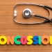 CONCUSSION colorful word on the wooden background