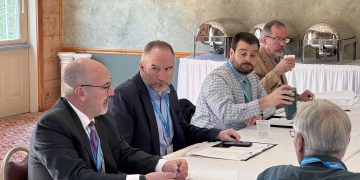 North Central Executive Director Jim Chorney, left, discusses a resolution regarding electronic signatures as, from left, Board Chair Dave Glass, Board Secretary/Treasurer Joe Haines, and First Vice Chair Matt Quesenberry look on.