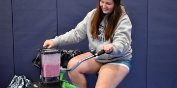 Penn State DuBois student Aleigha Geer pedals the smoothie bike during the 2023 Earth Day celebration at the PAW Center.

Credit: Penn State