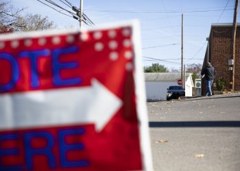A sign urging people to "vote here" on Election Day 2022.

Amanda Berg / For Spotlight PA
