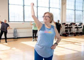 Patricia Creque, a graduate of the supervised exercise therapy program at Penn State Health Spring Ridge Outpatient Center, leads a dance class at Wyo West Fitness. Credit: Penn State Health. All Rights Reserved.