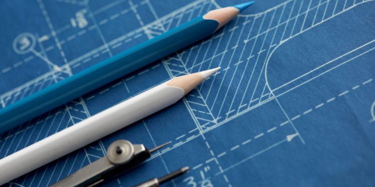 Markup tools lay on top of a blueprint on a table.

Credit: Adobe Stock