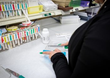 A pharmacy worker prepares a prescription.

Commonwealth Media Services