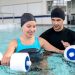 Young woman doing physical therapy in the water - healthcare and medicine