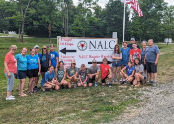 The members of the Christ Lutheran Church mission group are shown at the sign for the North American Lutheran Church (NALC) Disaster Response Warehouse and Retreat Center, Caldwell, Ohio. 
In the back row, from left, are: Mary Bates, Penny Prontock, Debbie Finalle, Pastor Amy Godshall-Miller, Hannah Fontaine, Tristin Fontaine, Grace Prontock, Madysn Sedor, Pastor John Miller, Addy Armagost, Charmaine Dungey and Jim Dungey. 
In front, from left, are: Marley Hemke, Avery Fontaine, Kamryn Fontaine, Ansen Armagost, Calix Myers, Drew London, Alexis Gibson and Virginia Myers.