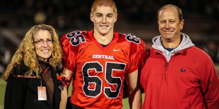 Timothy Piazza, along with his parents Evelyn and Jim, is seen in a photograph taken during his senior night in high school, prior to the events that unfolded during the initiation process of Penn State Beta Theta Pi fraternity in 2017. Photo courtesy of Patrick Carns.