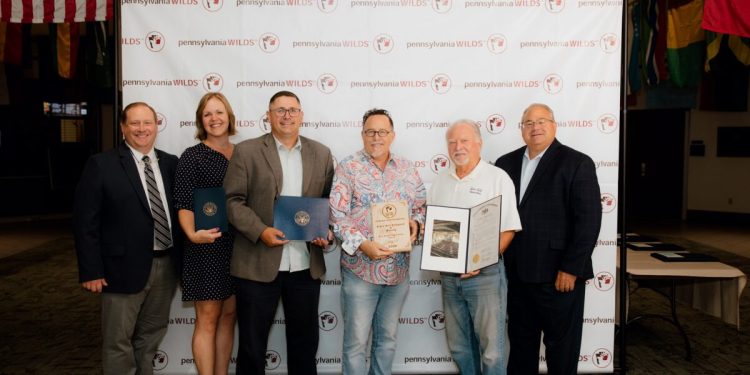 Pictured, from left to right, are: Shane Oschman (chair of the PA Wilds Board of Directors), Sen. Bob Casey's aide Liz Cooper, Congressman Glenn Thompson's aide Brad Moore, award recipient Kenn Starr, award recipient Ken Starr, and state Rep. Mike Armanini.