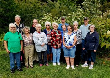 Pictured, from left to right, are some SEC members, Barb Homer, Lyle Millard, Trish Millard, Bob Homer, Sue Bell, Olive Plubell, Edwena Eger, Paul Tarachko Jr., Donna Tubbs, Susie Kline, Pat Ting, Richard Atkinson and Marianne Atkinson. 
The plants directly behind the group are invasive Japanese Knotweed with white flowers that can be seen on the right. Knotweed is capable of completely smothering out all other plant life, launching a domino effect that leads to other native species, like insects and birds, to leave the area as well. 
The SEC learned about Knotweed at a previous program by PSU Wildlife students.