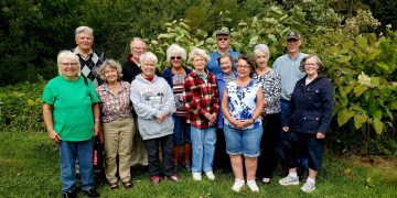 Pictured, from left to right, are some SEC members, Barb Homer, Lyle Millard, Trish Millard, Bob Homer, Sue Bell, Olive Plubell, Edwena Eger, Paul Tarachko Jr., Donna Tubbs, Susie Kline, Pat Ting, Richard Atkinson and Marianne Atkinson. 
The plants directly behind the group are invasive Japanese Knotweed with white flowers that can be seen on the right. Knotweed is capable of completely smothering out all other plant life, launching a domino effect that leads to other native species, like insects and birds, to leave the area as well. 
The SEC learned about Knotweed at a previous program by PSU Wildlife students.