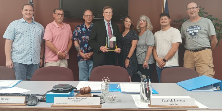 Chip Bell (center) received an award from Clearfield Borough Council in honor of his over 30 years of service to the area.