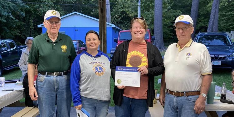 Pictured, from left to right, are:  Martin Tate, GLC president; Erin Dimmick, sponsoring Lion; Kimmy Wheeler, new member; and Jim Bennett, GLC  installing officer.