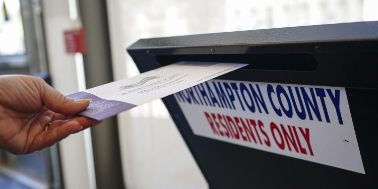 A voter puts a ballot into a drop box on primary Election Day 2024 at Bethlehem City Hall in Northampton County, Pennsylvania.

Matt Smith / For Spotlight PA