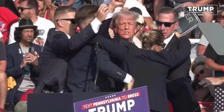 Former President Donald Trump, surrounded by U.S. Secret Service agents, pumps his first after pops were heard at his rally in Butler, Pa., on July 13, 2024. 

Donald J. Trump | Facebook