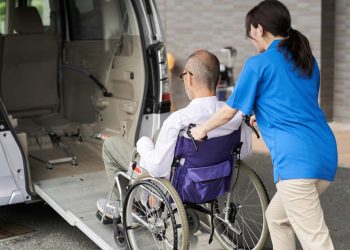 A caregiver who puts an elderly person in a long-term care taxi