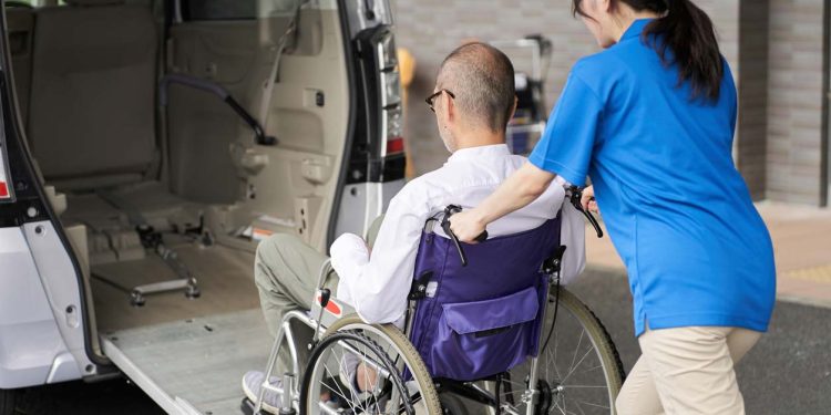 A caregiver who puts an elderly person in a long-term care taxi