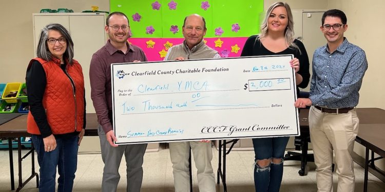 A 2024 Clearfield County Charitable Foundation Community Project Grant is presented to the Clearfield YMCA Summer Day Camp Program to pay for the remodeling project of the day camp room.    Pictured, from left, are: CCCF Grant Committee Chair Lisa Kovalick, YMCA Executive Director Brian McDonald, CCCF Board Chair Jeb Soult, Summer Day Camp Program Director Karter Bell and CCCF Board Member Shayne Lumadue.  