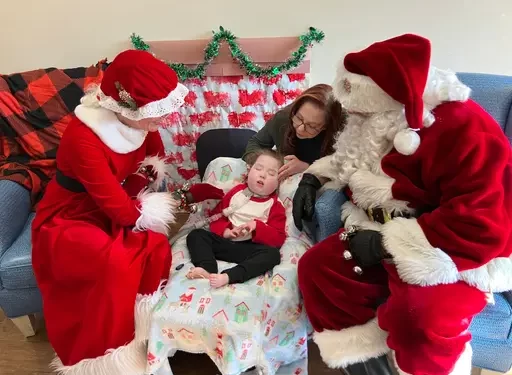 Santa and Mrs. Claus sit with a child and his mother at the Children's Home of Pittsburgh.

Sarah Boden / For Spotlight PA