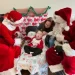 Santa and Mrs. Claus sit with a child and his mother at the Children's Home of Pittsburgh.

Sarah Boden / For Spotlight PA