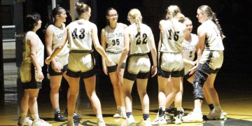 The Curwensville girls basketball team gathers at midcourt after pregame introductions at Patton Hall. (Photo by Rich Murawski)